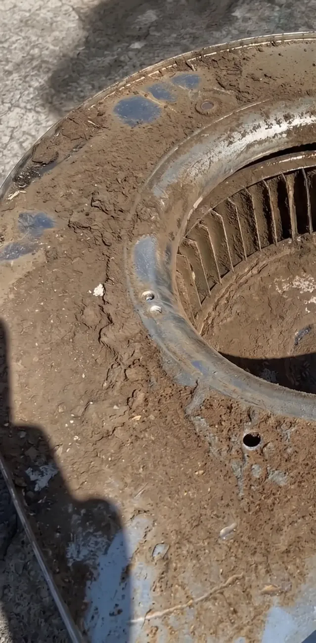 Furnace blower wheel and housing caked with dirt and grime before cleaning