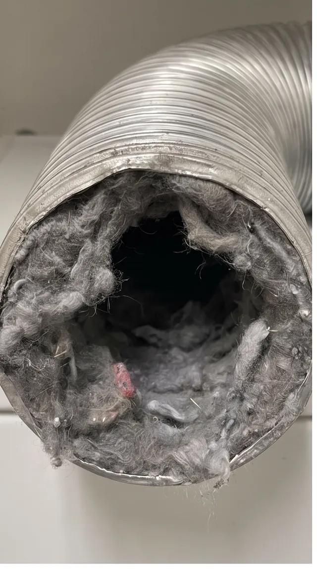 Flexible dryer exhaust duct packed solid with lint before cleaning